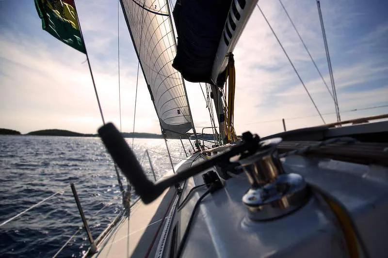 A sailboat crosses Table Bay off the Cape Town coastline.