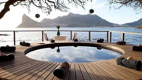 An ocean-facing deck and plunge pool at Tintswalo Atlantic.
