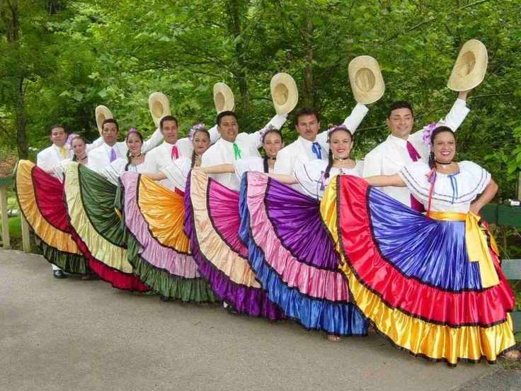 Dancers in colorful traditional costumes perform in a line.