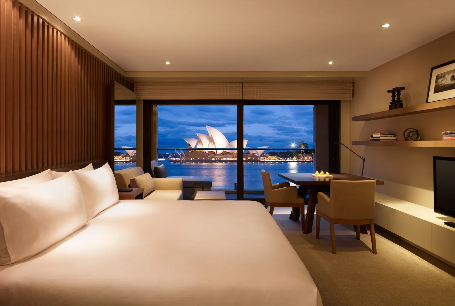 A guest room at Park Hyatt Sydney with a view toward the harbour.