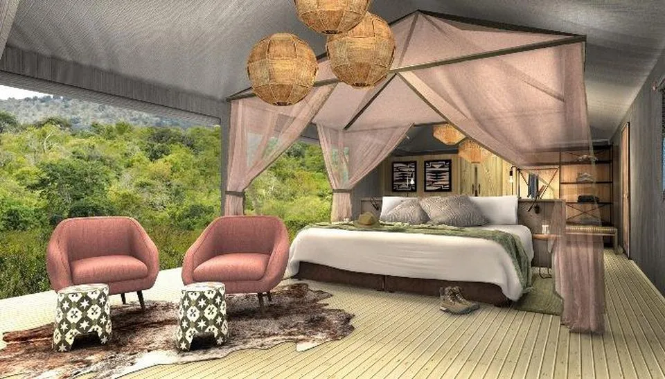 Inside a canvas tent suite at Magashi Camp, with a large bed and seating area.