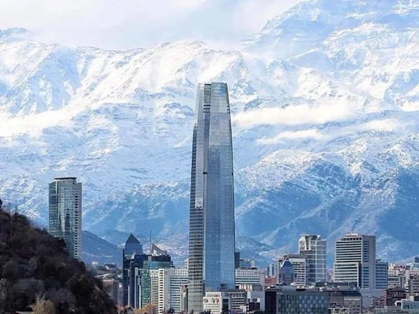 Santiago's skyline with snow-covered mountains in the background.