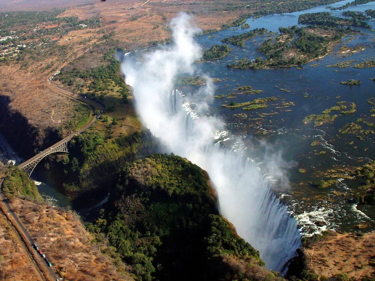 Aerial view of a waterfall plunging into a gorge.