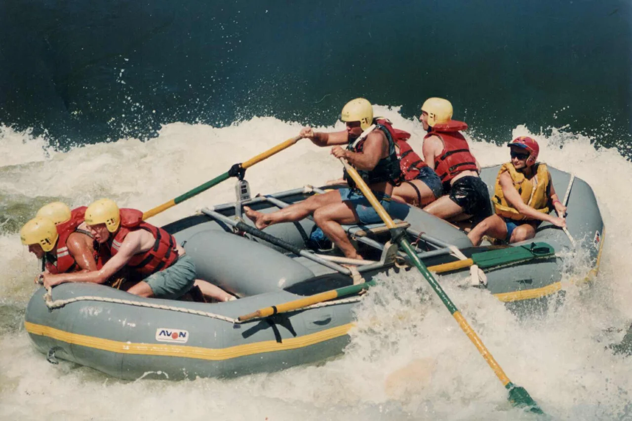 A group rafting through white-water rapids.